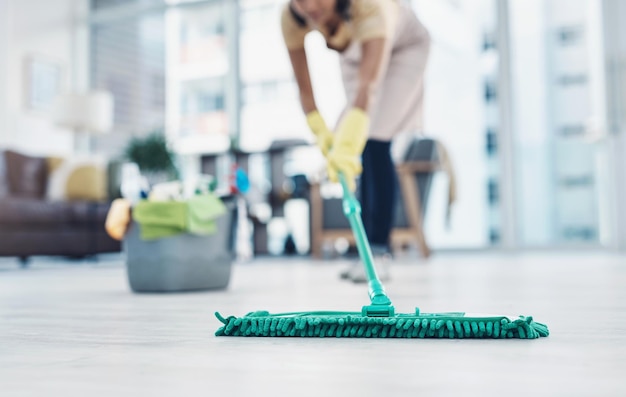 The countdown to clean shiny floors Shot of an unrecognisable woman mopping the floor at home