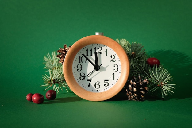 Countdown to midnight wood alarm clock with fir tree decorated with pine cones and cranberry