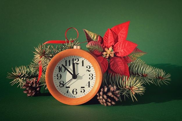 Countdown to midnight wood alarm clock with poinsettia fir tree and pine cones green paper