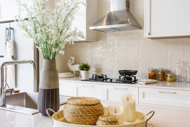 Counter top with fruits and vegetable on a brown color clay dish next to the modern silver