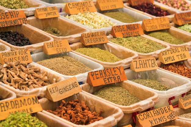 Countertop with a variety of spices tea and flavourings in containers background