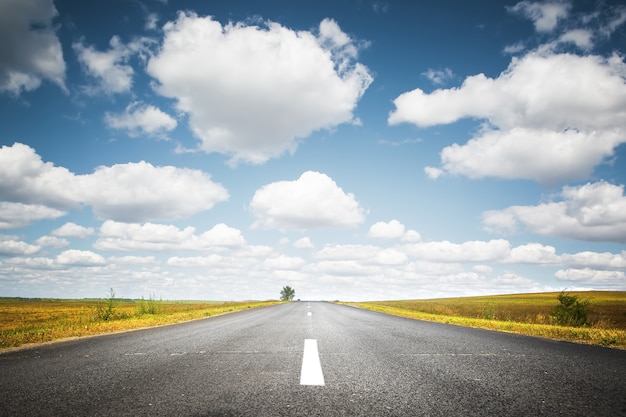 Country road with a clouds asphalt