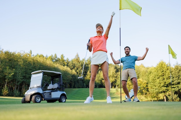 Photo couple achieving win at final golf hole