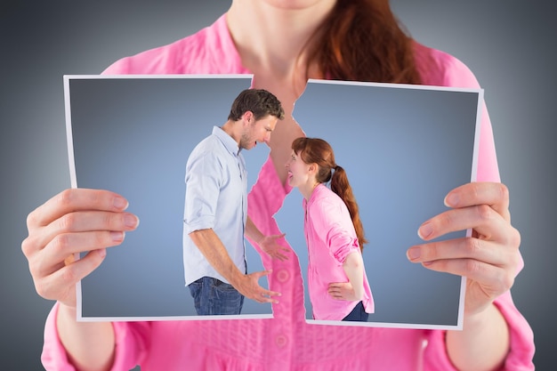 Couple arguing with each other against grey vignette