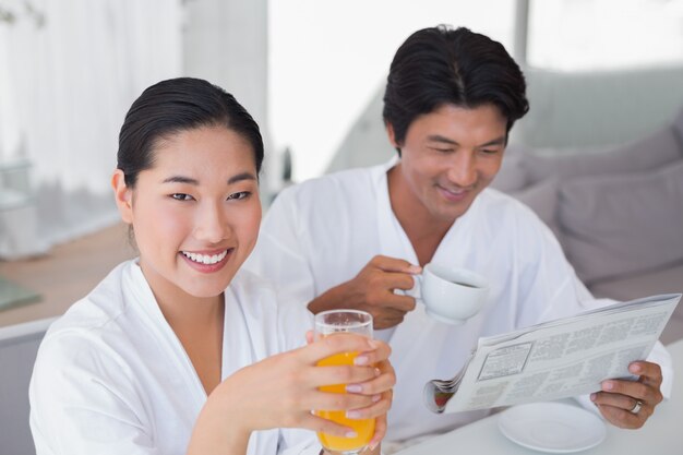 Couple in bathrobes spending the morning together