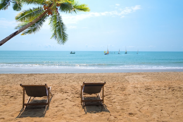 Couple of beach chairs on tropical beach