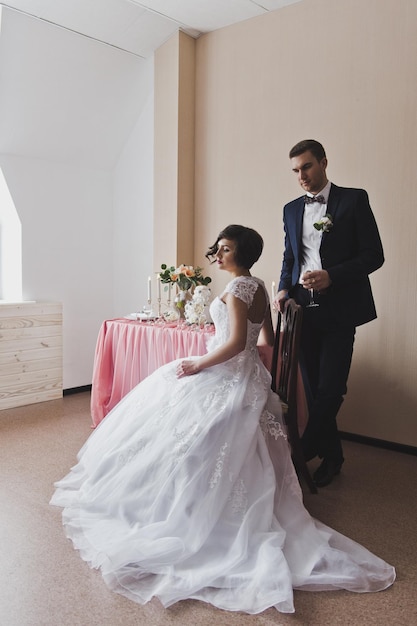 The couple in beautiful outfits sitting at a beautiful table 6455