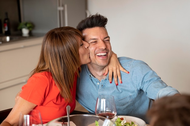 Couple being romantic at family dinner