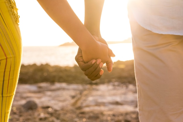 couple of black race african hands touch and take them in a love forever together concept