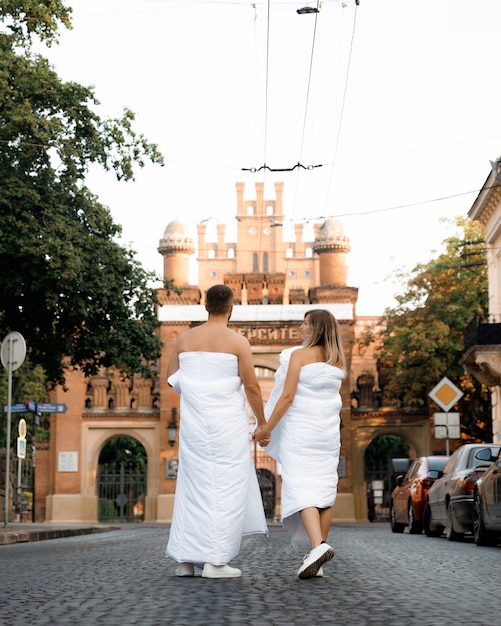 A couple in blankets walking around the city