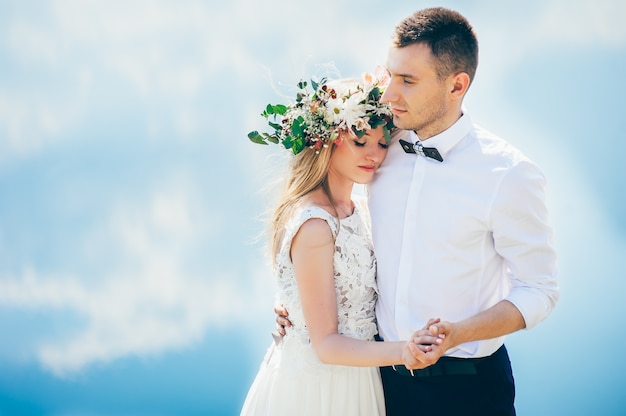 couple on blue sky background, water