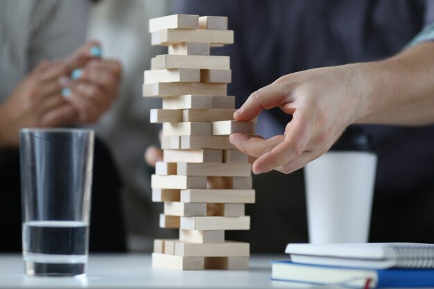 Couple build tower from wood blocks