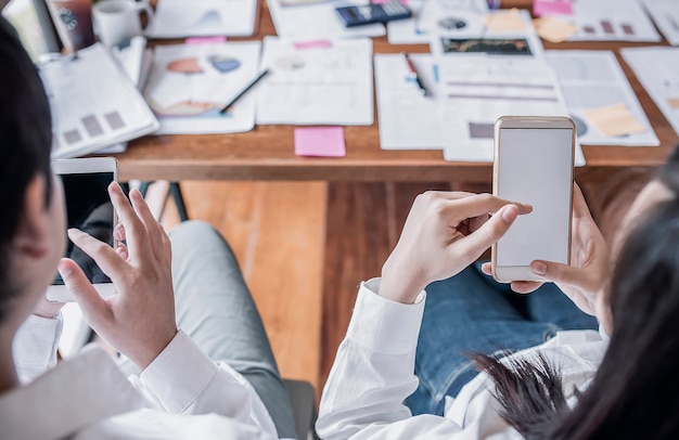 couple of business people using smartphone at work