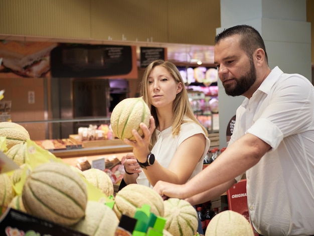 Couple buy fruits at supermarket