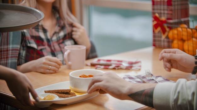 A couple in cafe having a lunch and about to eat the porridge