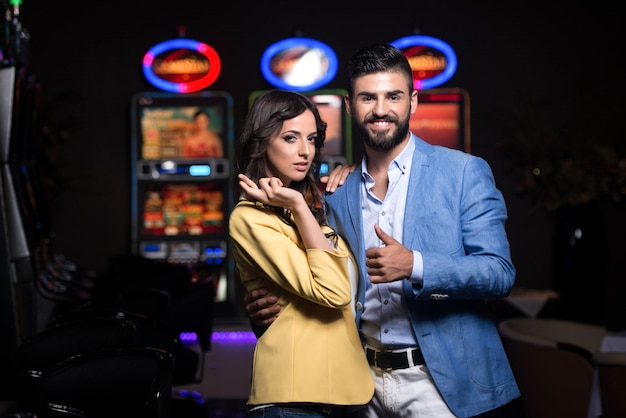 Couple in Casino Showing Thumbsup and Cross Finger