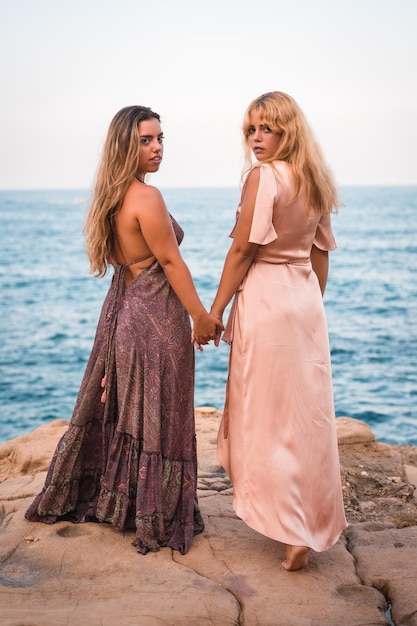 A couple of Caucasian girls with beautiful dresses enjoying the summer