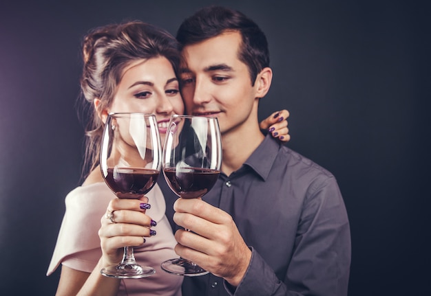 Couple celebrating drinking red wine