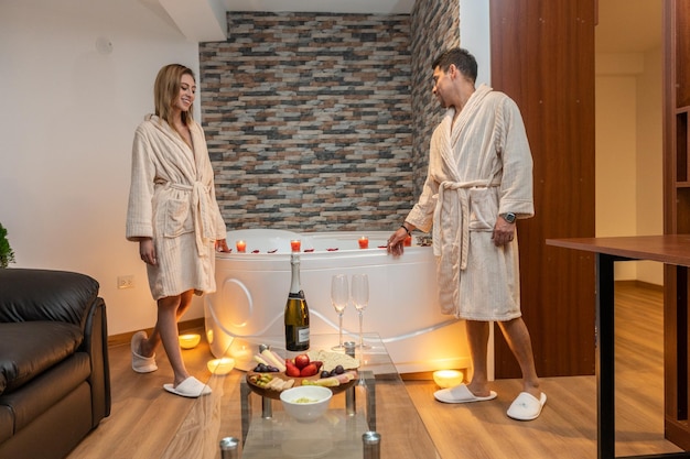 Couple celebrating a romantic evening for Valentine's Day in a hotel with a jacuzzi.