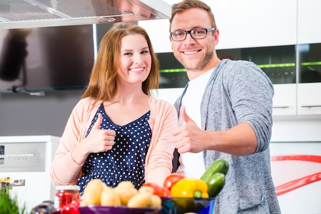 Couple cooking pasta in domestic kitchen