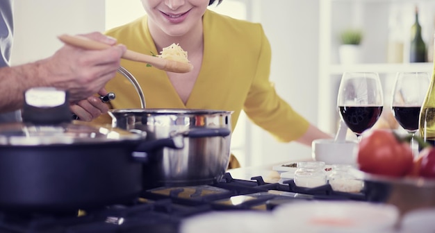 Couple cooking together in the kitchen at home