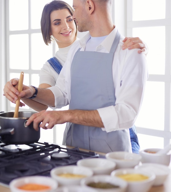 Couple cooking together in the kitchen at home