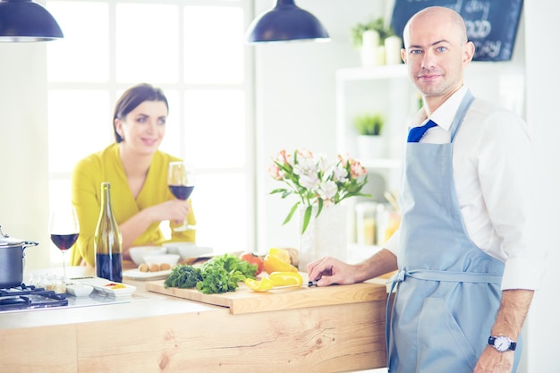 Couple cooking together in the kitchen at home