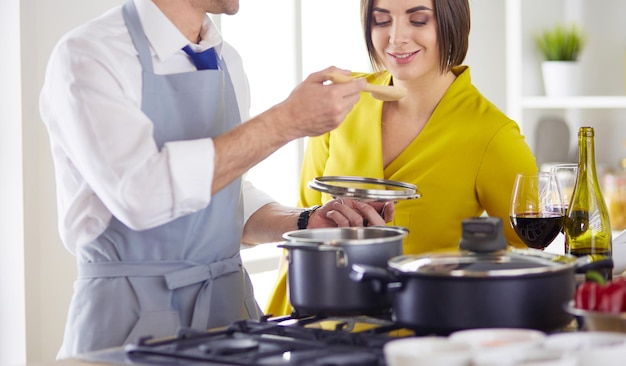 Couple cooking together in the kitchen at home