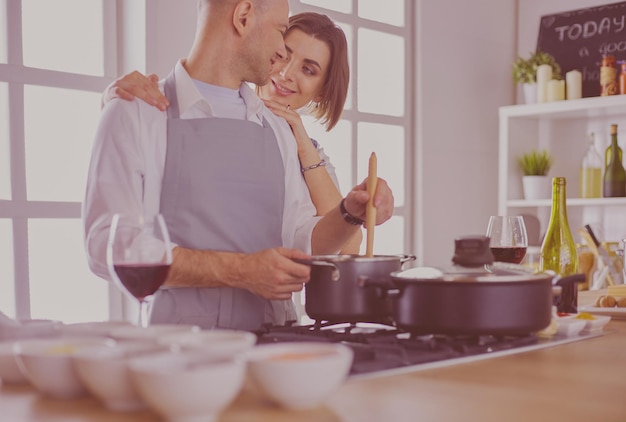 Couple cooking together in the kitchen at home