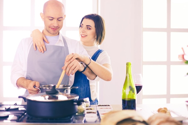 Couple cooking together in the kitchen at home