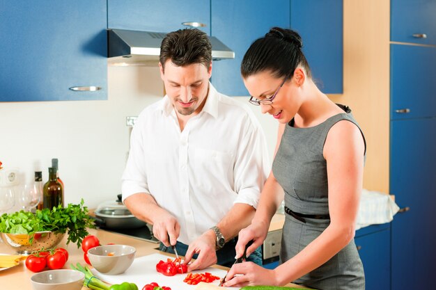 Couple cooking together in kitchen