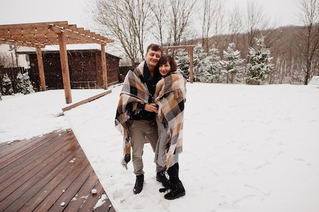 Couple covered blanket in winter day spending time together in love