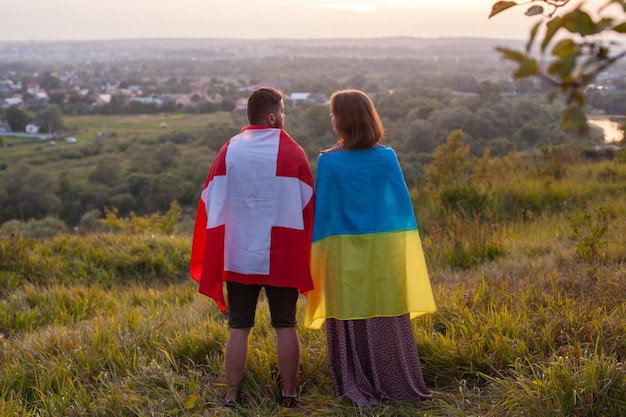 Couple covered in Ukraine and Switzerland flags