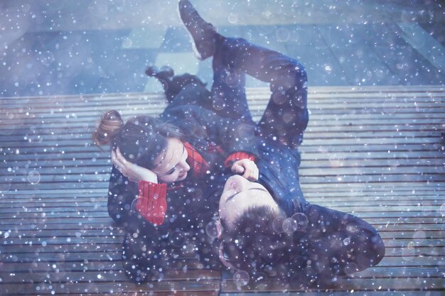 couple cuddling on a bench in winter