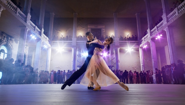 Couple dancers perform waltz on large professional stage Ballroom dancing