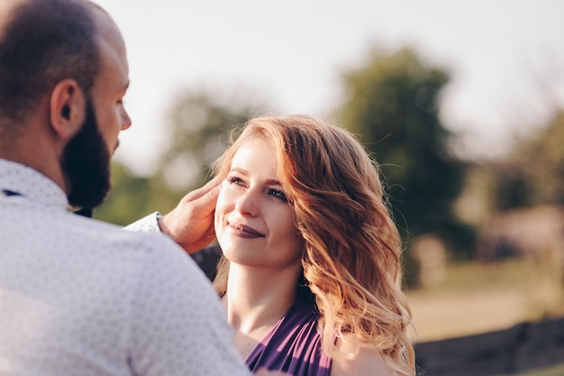 Couple on a date. Purple dress. Bride and groom. Walk in the field. Love story.