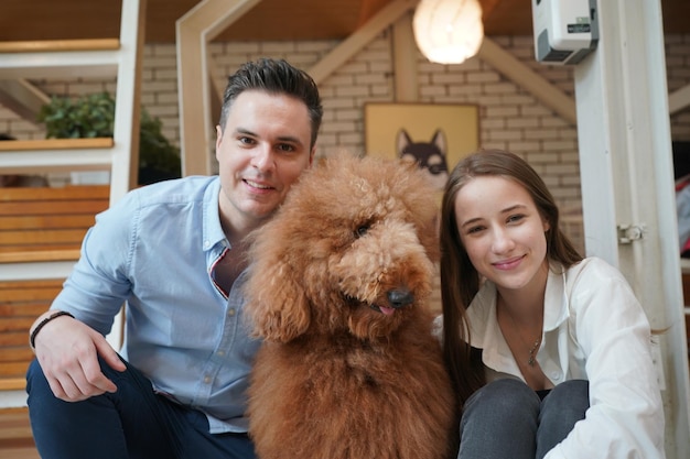 Couple and dog lying on floor