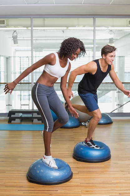 Couple doing aerobics on bosu balls