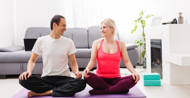 couple doing exercises at home. Yoga concept.