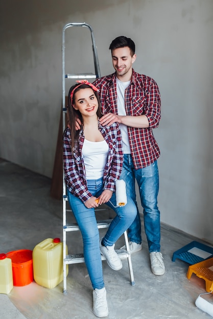 Couple doing home improvements,man doing massage for him girl,