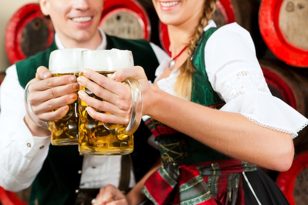 Couple drinking beer in brewery