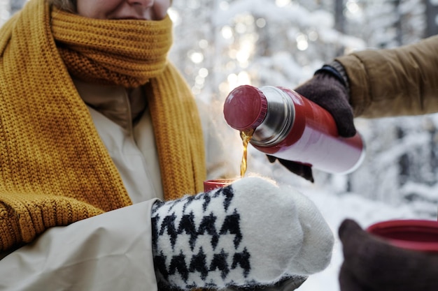 Couple drinking hot tea outdoors