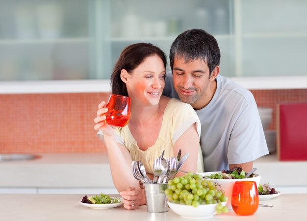 Photo couple eating and drinking in the kitchen