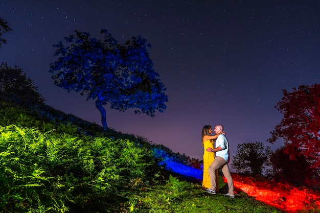 A couple embraced at night from Mount Erlaitz in the town of Irun Guipuzcoa