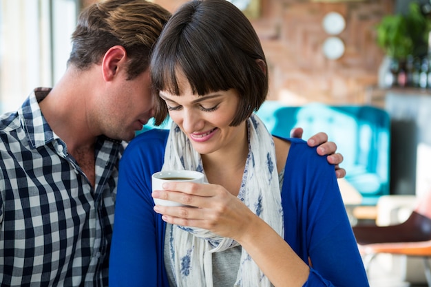 Couple embracing in coffee shop