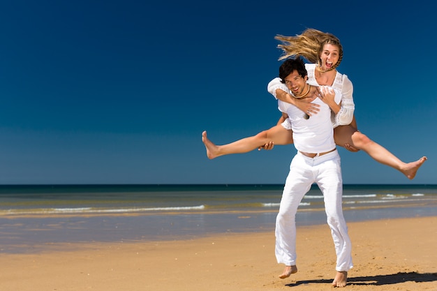 Couple enjoying freedom on the beach