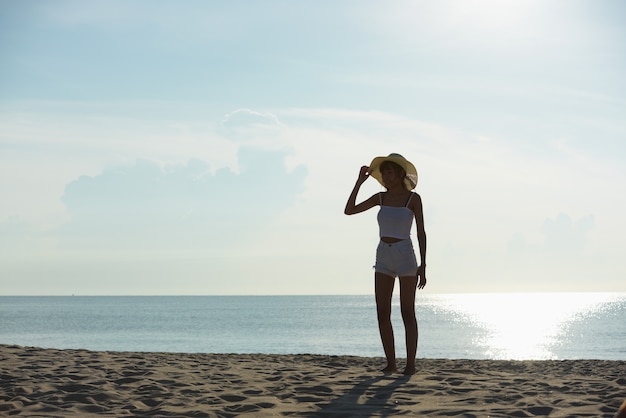 couple Exercise Do yoga at the beach and jump at the beach in the early morning sunrise.