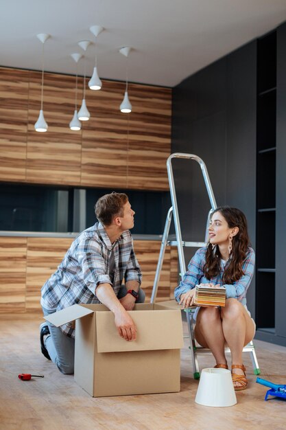 Couple feeling busy while unpacking and moving