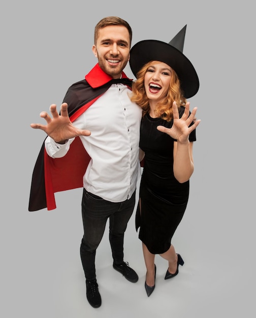 Photo couple in halloween costumes of witch and vampire