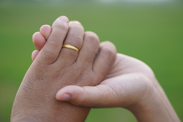 Couple hands holding each other